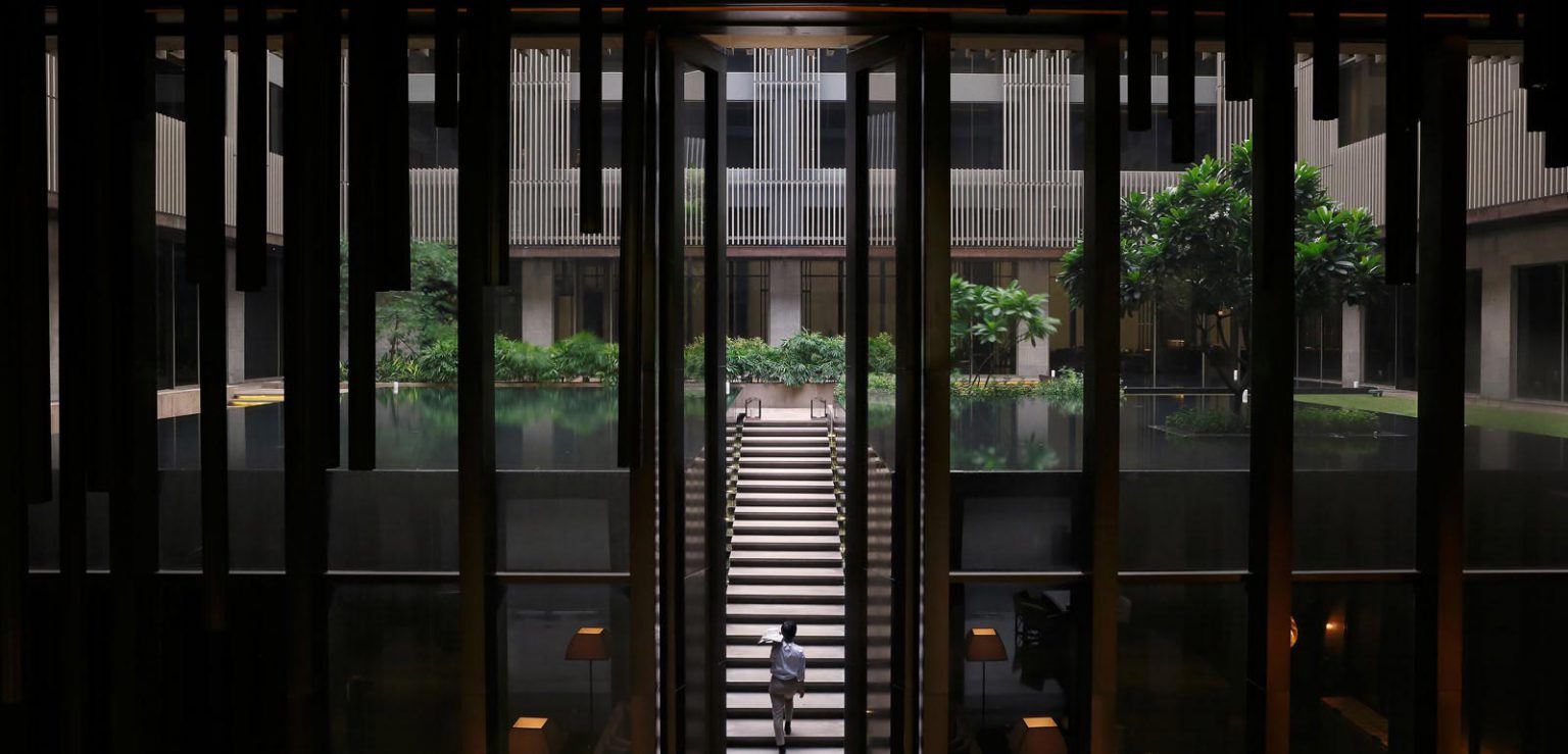 Dark shot of a hotel worker walking up stairs