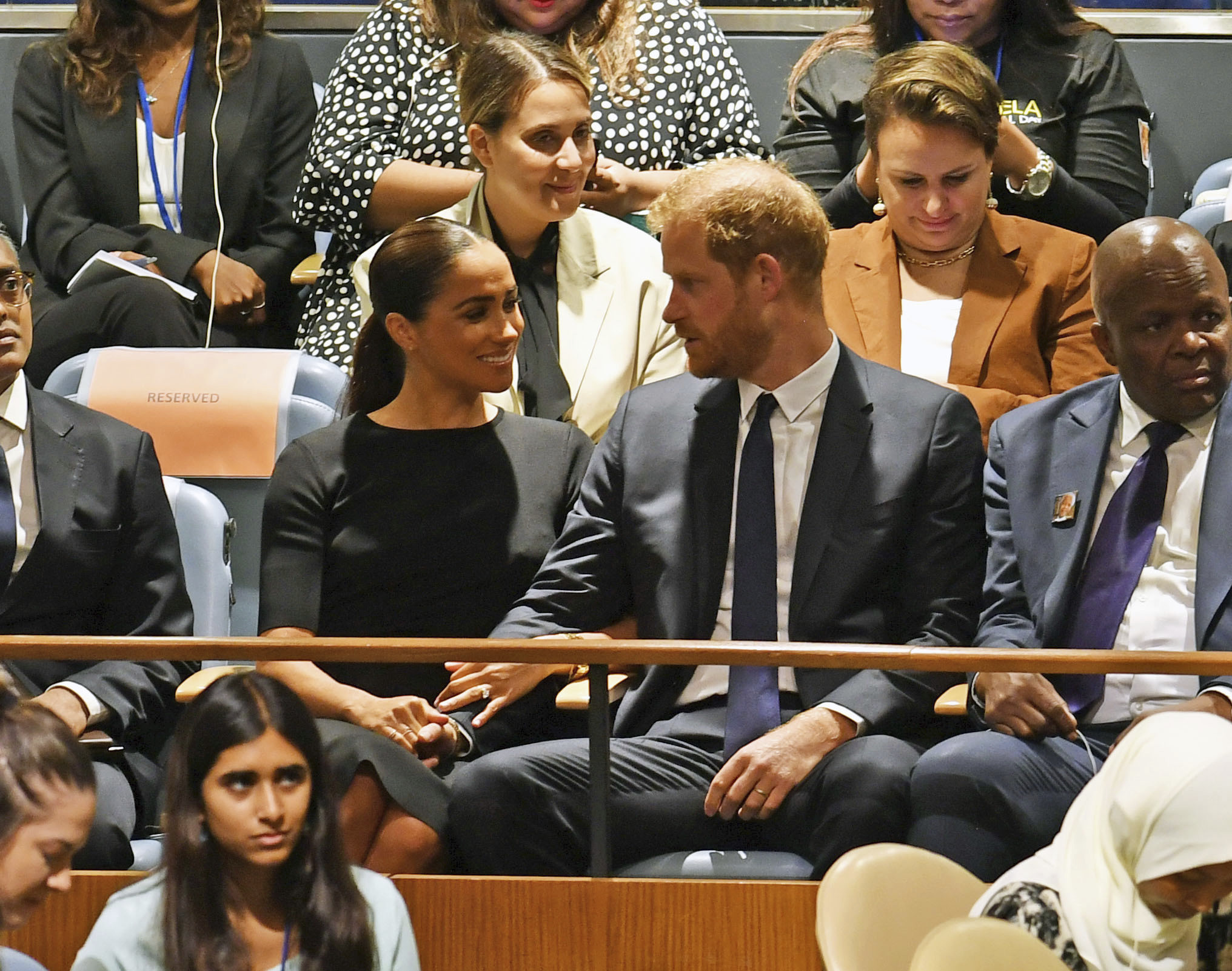 A man and a woman speaking while seated.