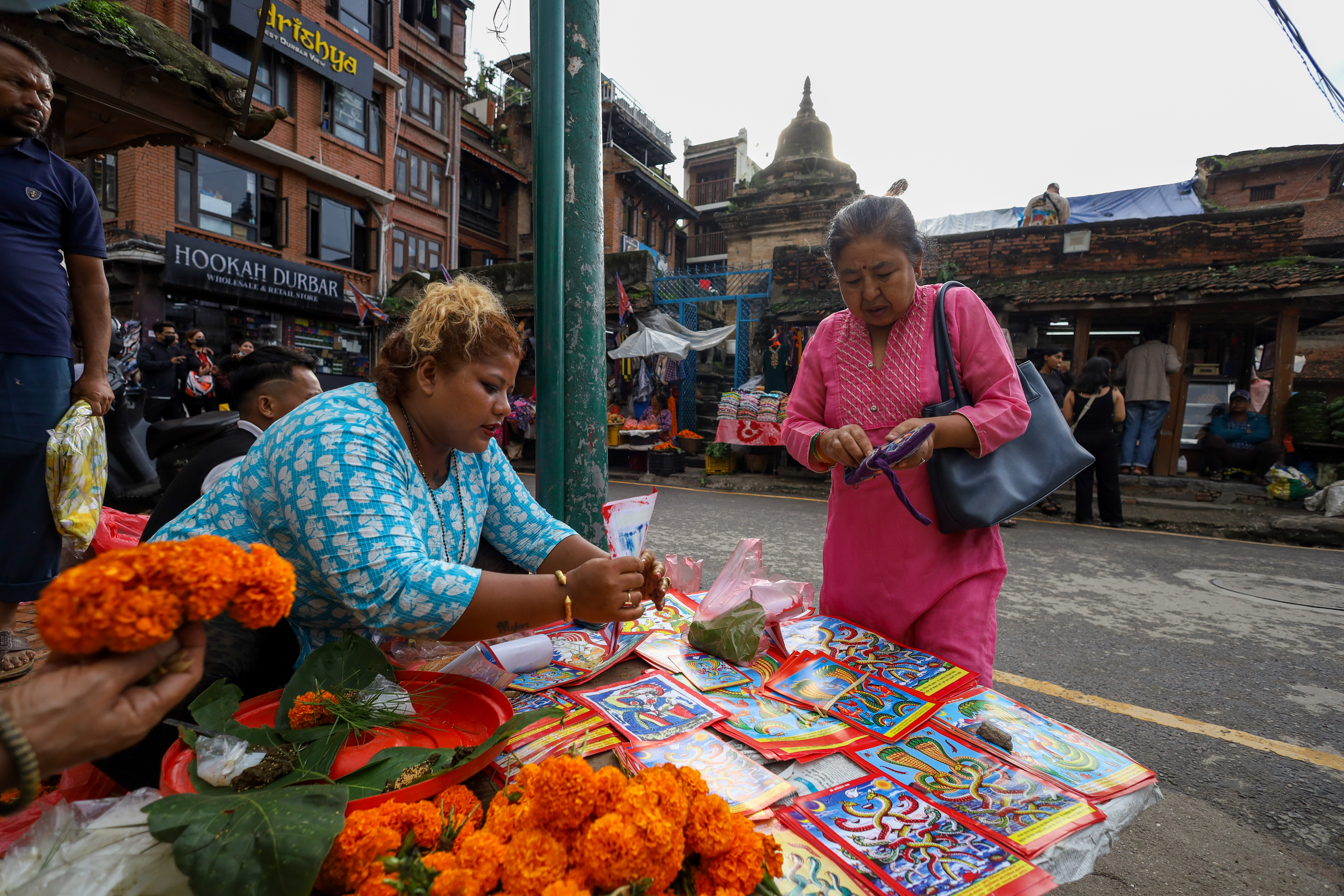 Vendors at a local market near the Patan Durbar Square, a UNESCO World Heritage Site, selling pictures of the serpent deity (naga) ahead of the Nag Panchami festivities in Lalitpur, Nepal.