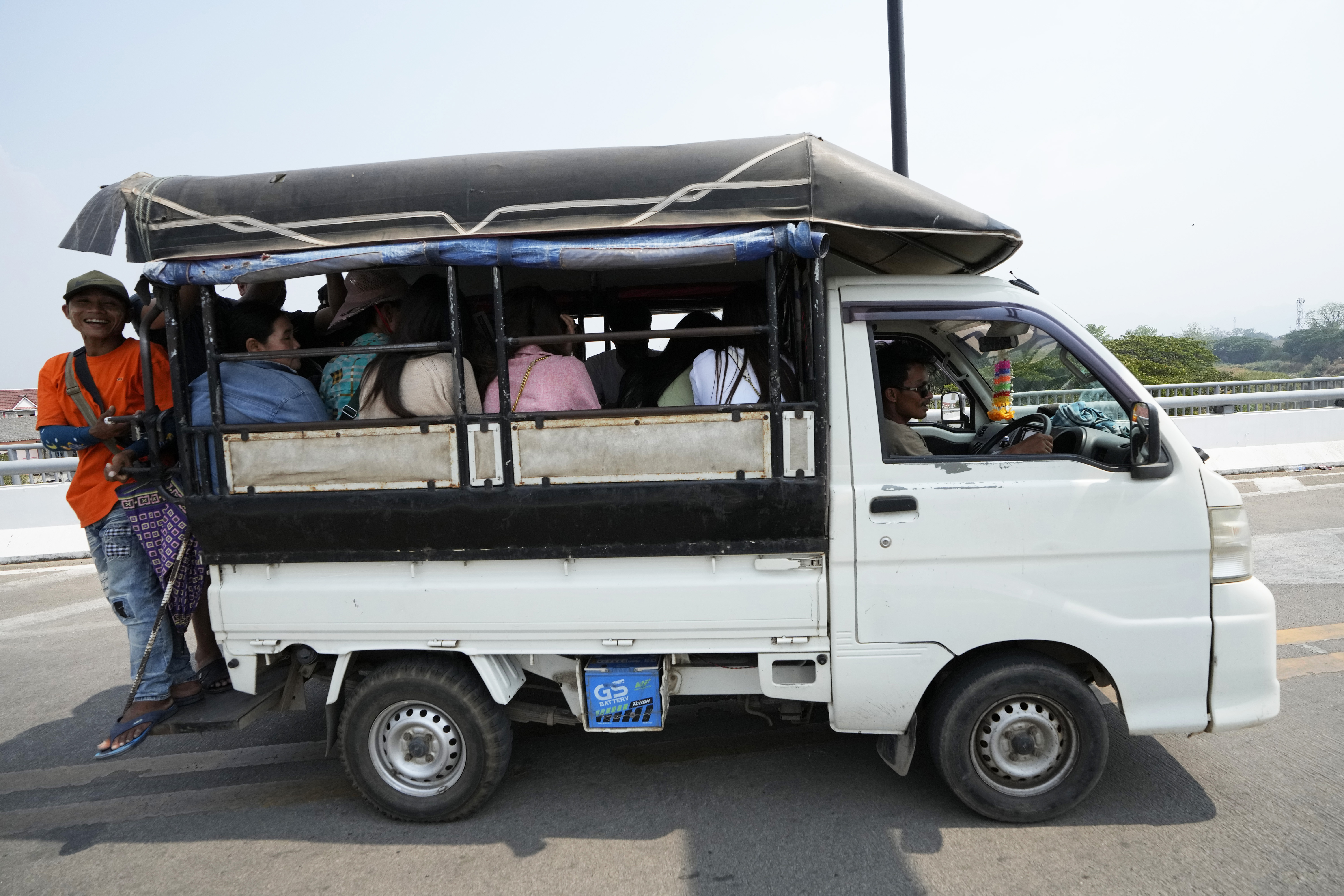 A group of people on a small vehicle.