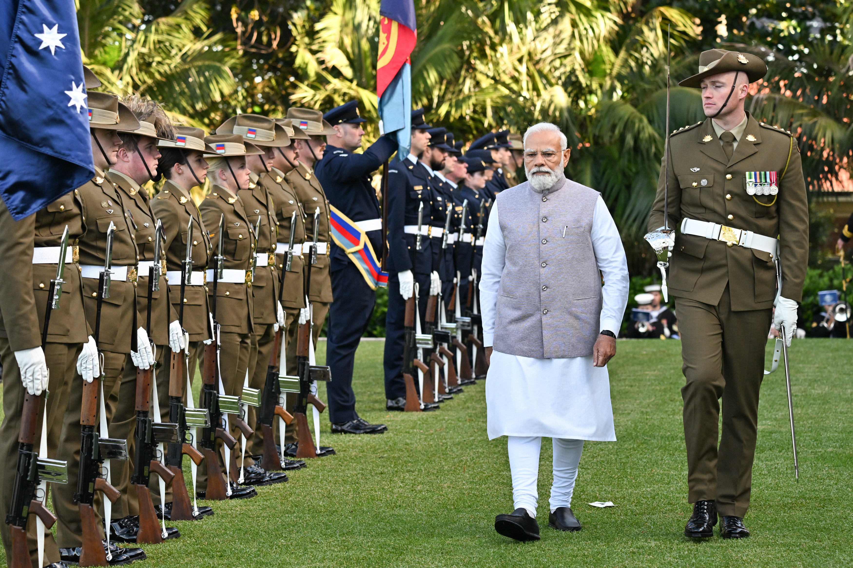 Man walks in front of line of soldiers.