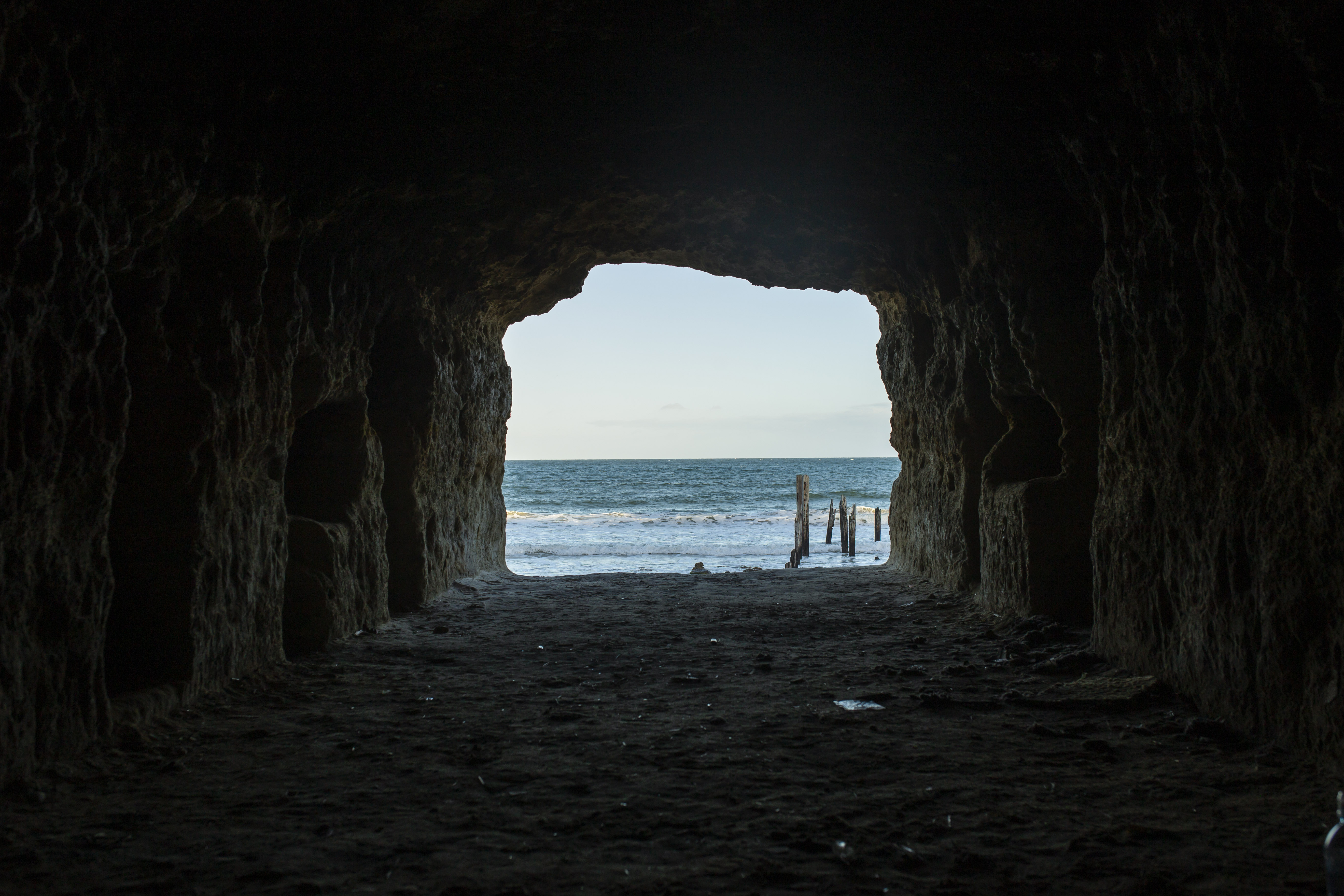 beach view through a dark cave
