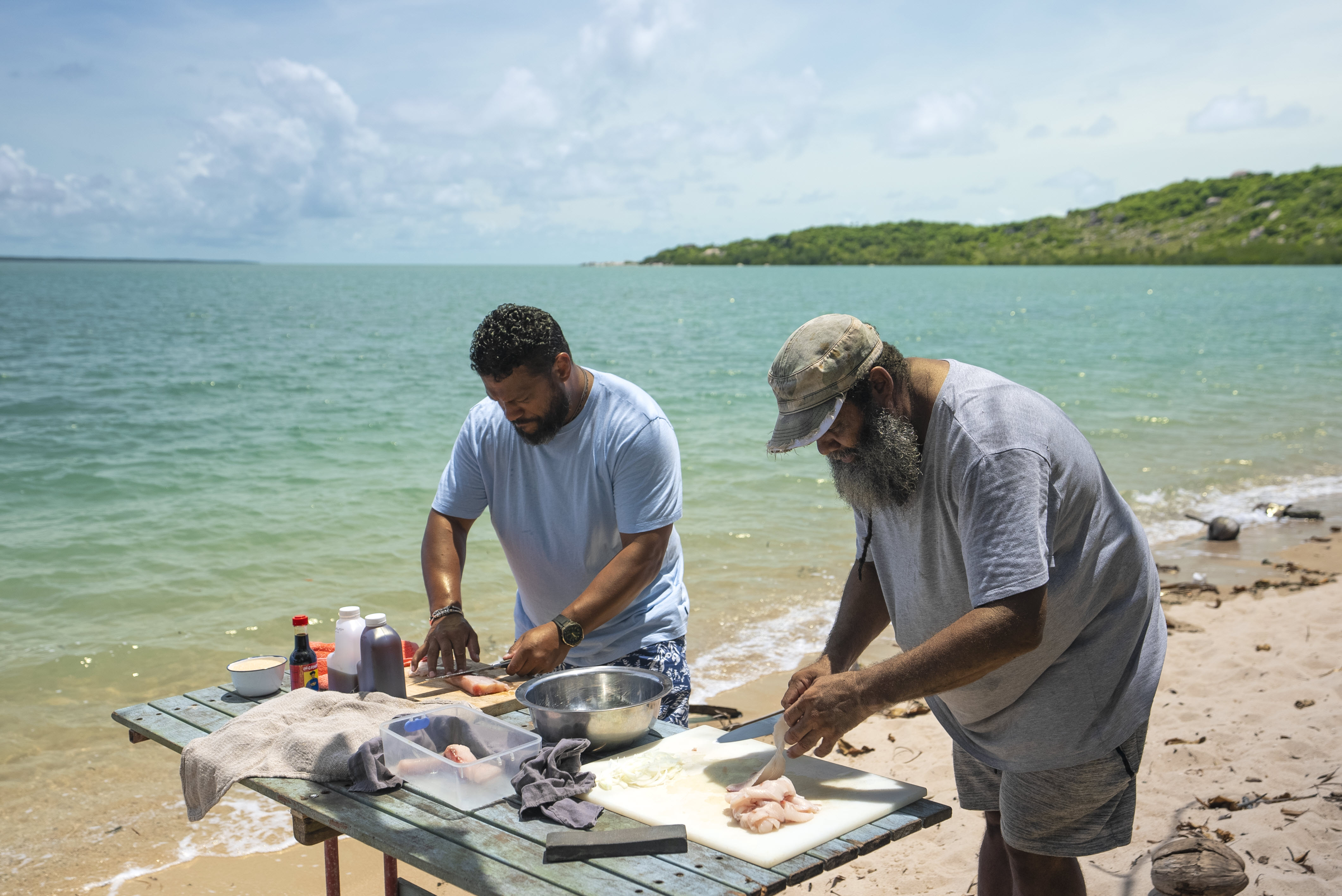 Aaron Fa’aso helps fisherman and diver, Uncle Tommy, to make namas in episode five of Strait to the Plate on SBS.