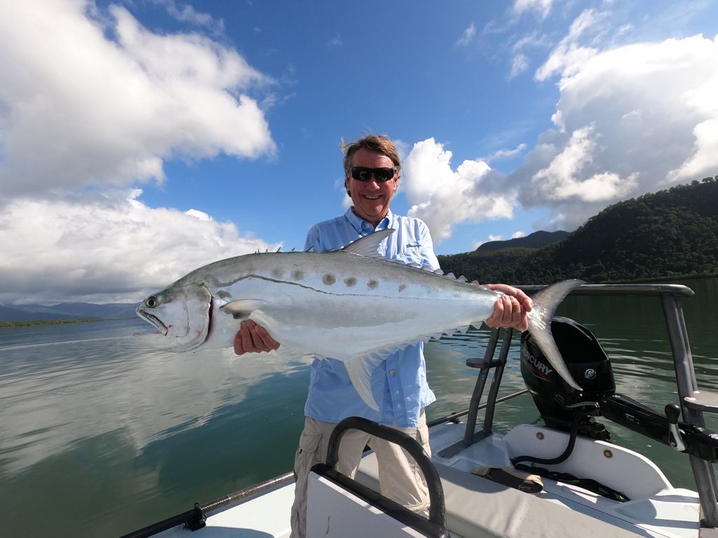 Stephen Simpson showing a queenfish he caught.