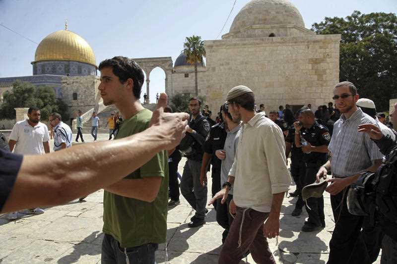 A group of religious Jews escorted by Israeli police at Al-Aqsa Mosque compound in Jerusalem