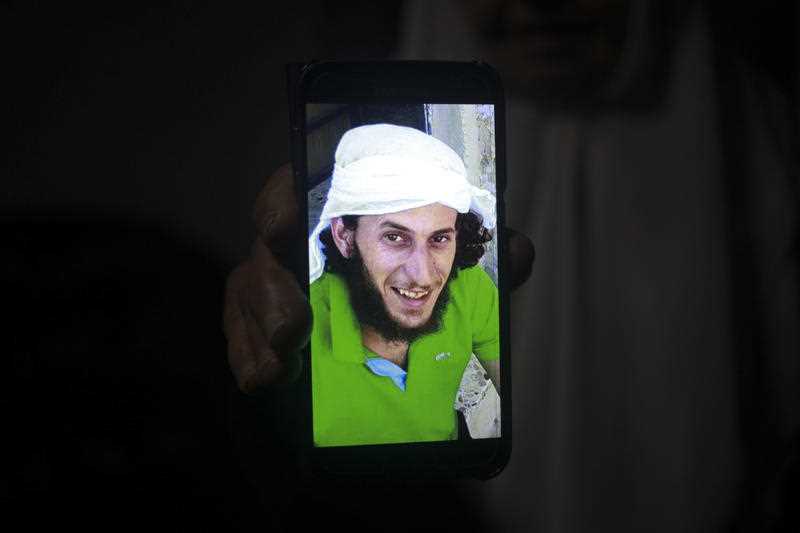 A relative shows a photo of Fadi Kunbar, 28, outside his home in Jerusalem, Sunday, Jan. 8, 2017.