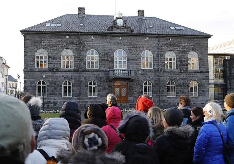 file photo of people looking at the Icelandic parliament the Althing in Reykjavik.