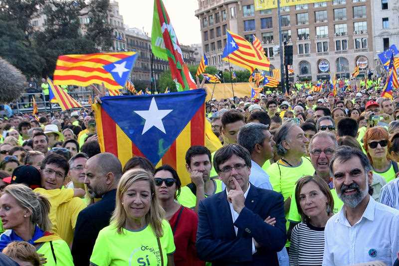 The President of the Government of, Catalunya Carles Puigdemont (pictured centre right) takes to the street as hundreds of thousands of Catalans take to the streets of Barcelona, Spain, 2017.