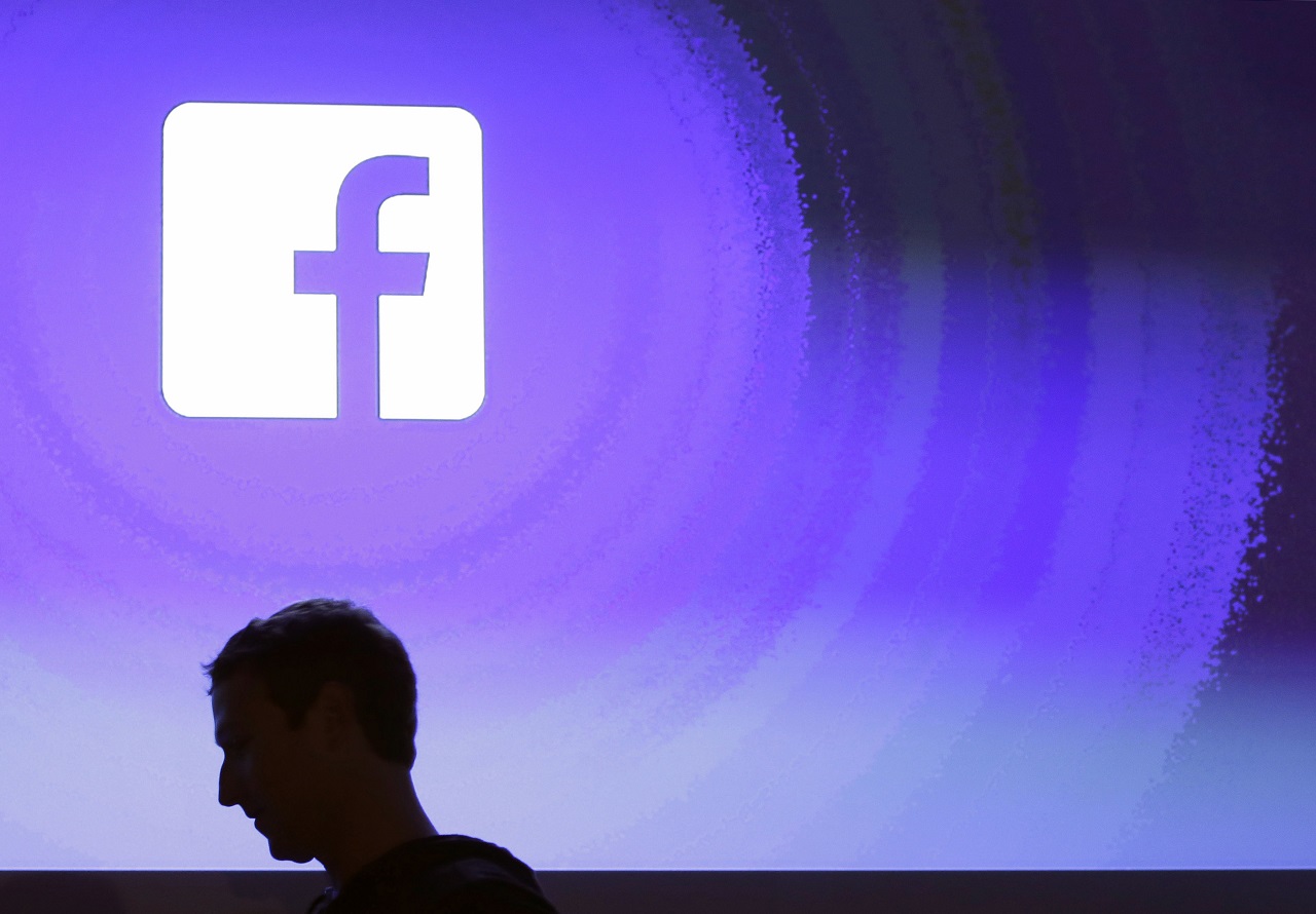 Facebook CEO Mark Zuckerberg walks at the company's headquarters in Menlo Park, Calif. 