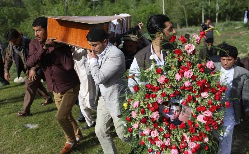 Relatives and friends attend the funeral of AFP photographer Shah Marai, who was killed in the twin bomb blasts in Kabul, Afghanistan