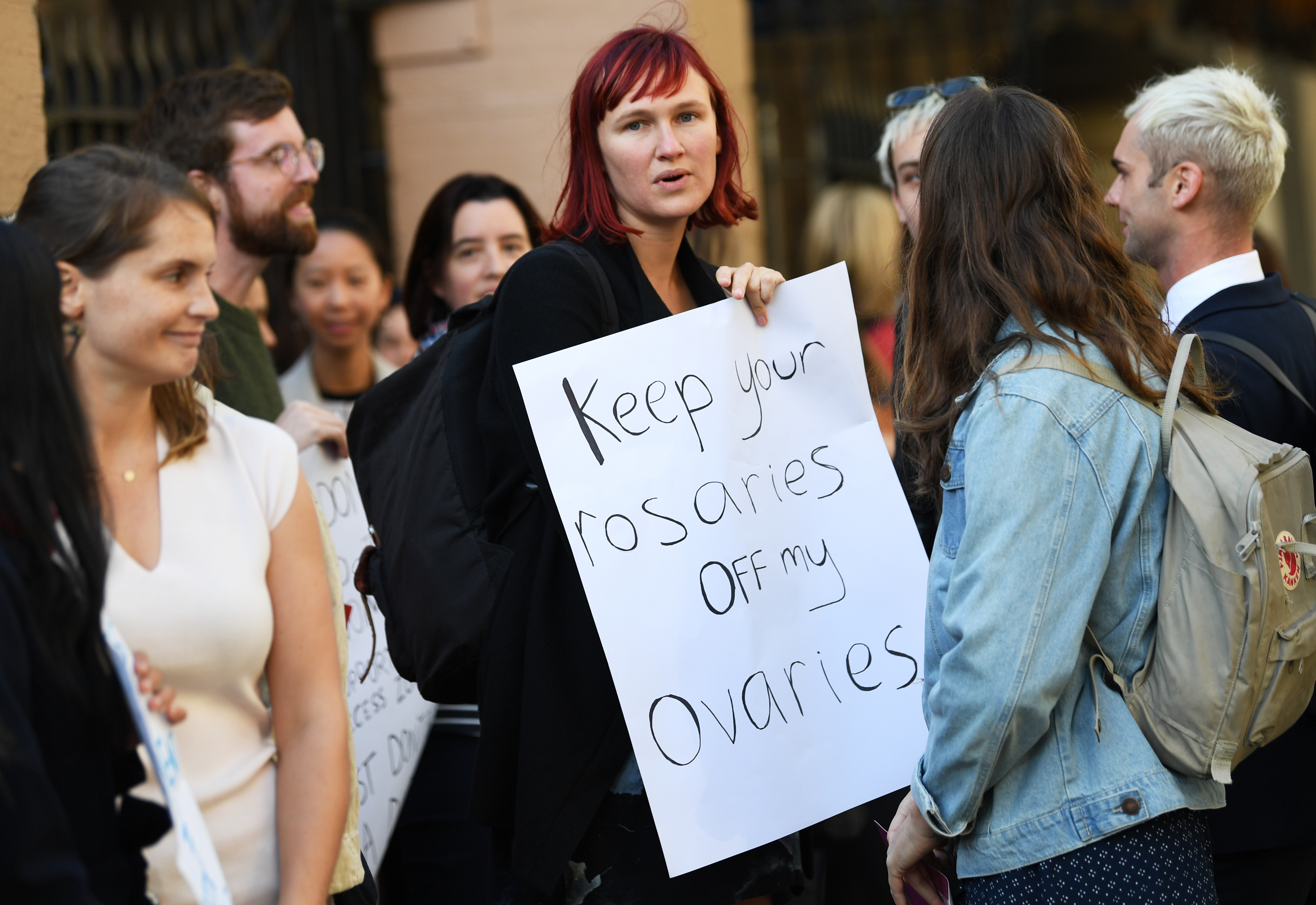 Demonstrators in favour of safe buffer-zones around NSW abortion clinics stand outside the NSW State Parliament building in Sydney, Thursday, May 24, 2018.