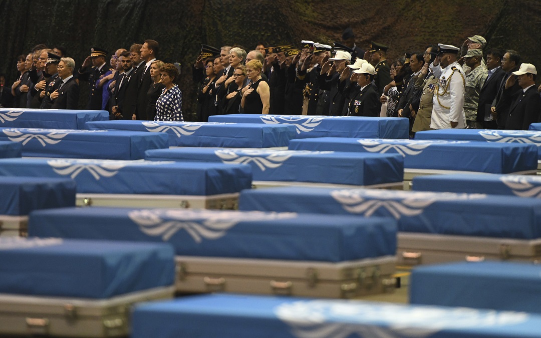 Attenders salute during a repatriation ceremony for the remains of US soldiers who were killed in the Korean War.