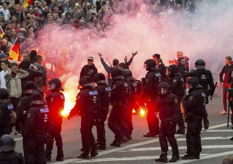 German riot police confront far-right protesters in the city of Chemnitz. 