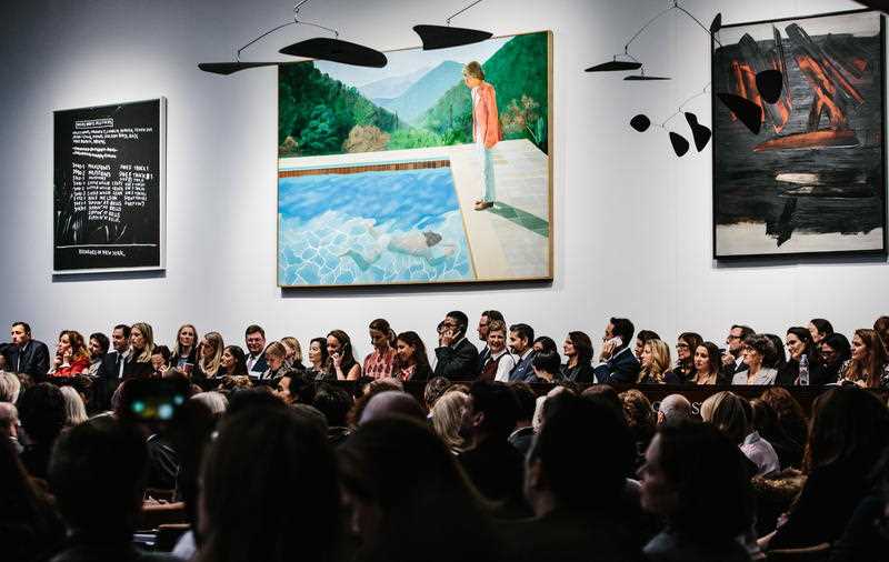 The painting 'Portrait of an Artist (Pool with Two Figures)' by artist David Hockney (C) during the historic auction.
