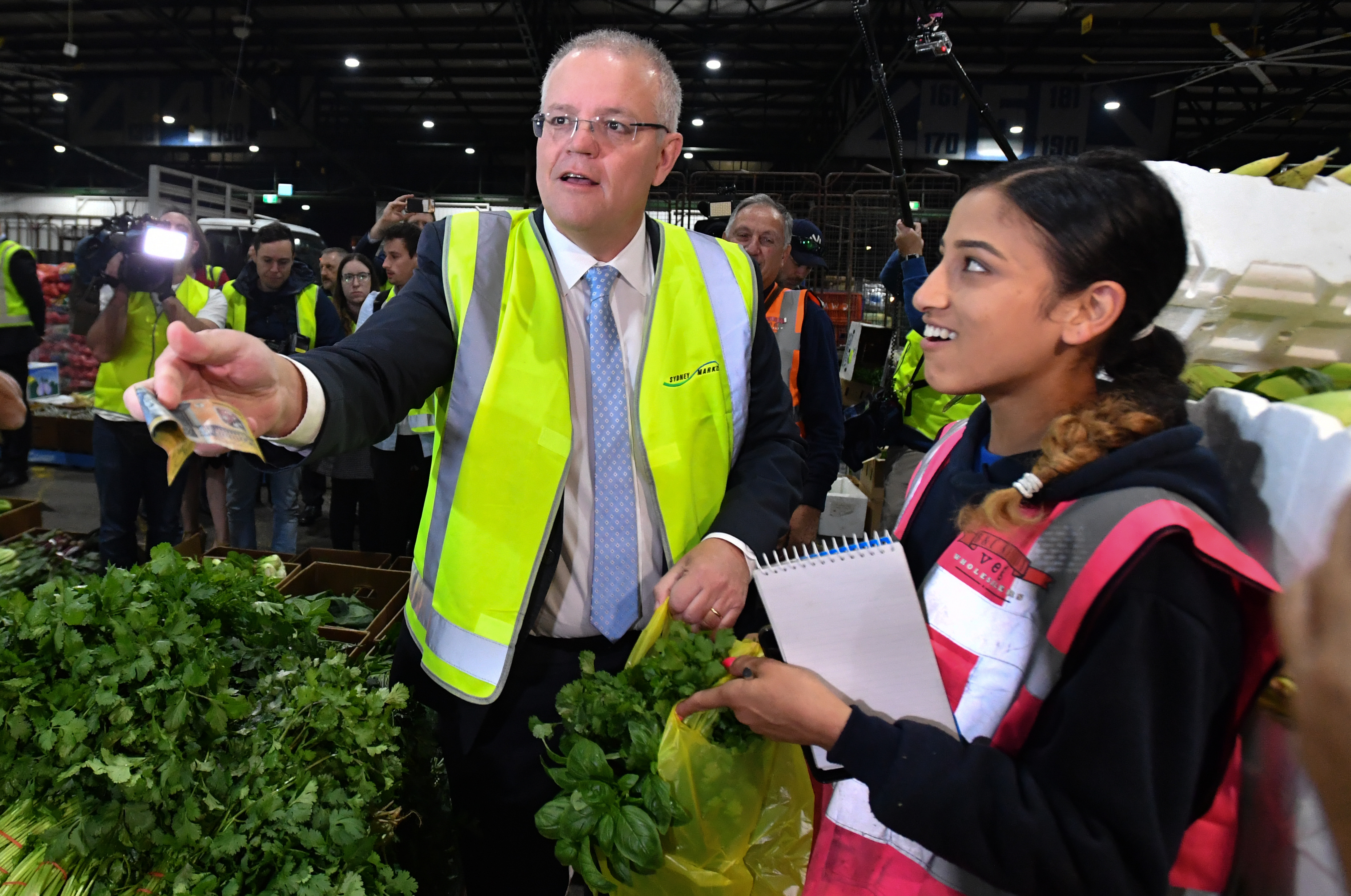 Prime Minister Scott Morrison buys basil during a visit to Flemington markets in  Sydney, Thursday, May 16, 2019. (AAP Image/Mick Tsikas) NO ARCHIVING