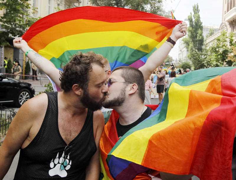 Participants kiss during a Gay pride parade or March of Equality in down town Kiev