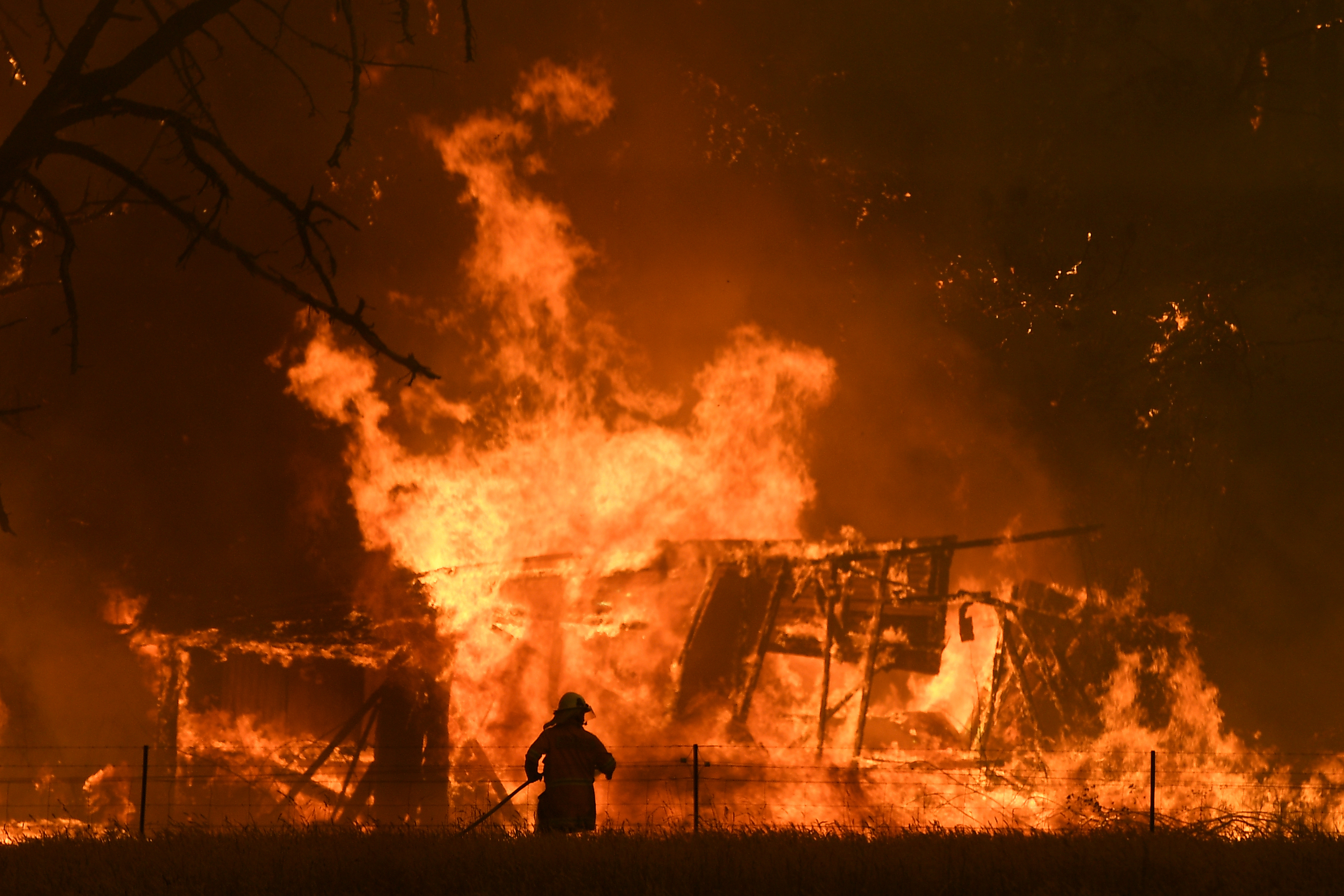 NSW Rural Fire Service crews fight the Gospers Mountain Fire as it impacts a structure at Bilpin, Saturday, December 21, 2019. Conditions are expected to worsen across much of NSW as temperatures tip 40C. (AAP Image/Dan Himbrechts) NO ARCHIVING