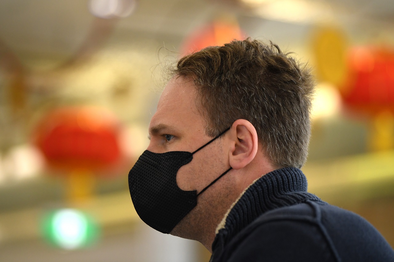 A passenger wearing a protective mask on arrival at Sydney airport. 