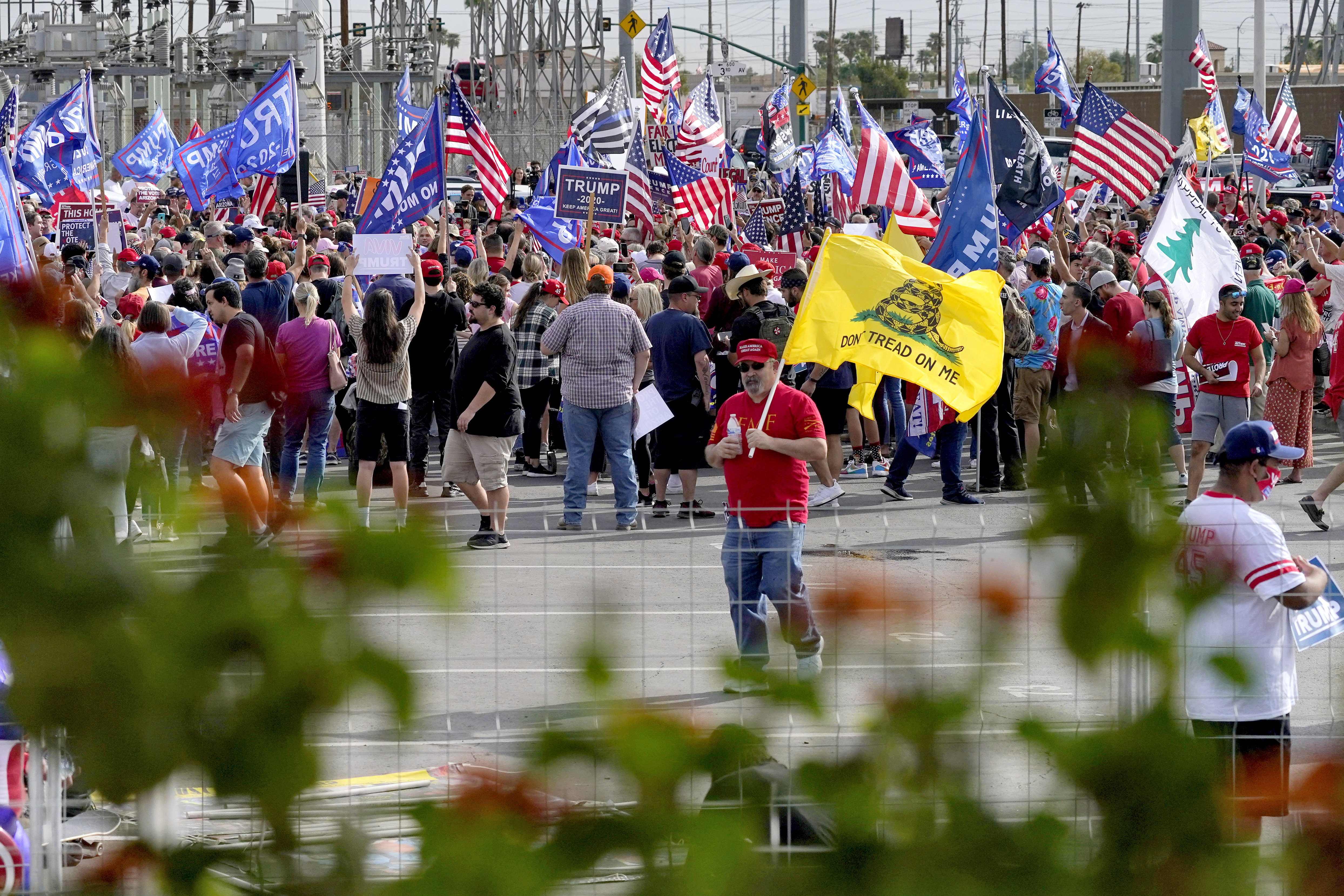 Crowds gather during a pro Trump rally outside the Maricopa County Recorder's Office where elections officials continue to count ballots for the general election, Friday, Nov. 6, 2020, in Phoenix. (AP Photo/Matt York)