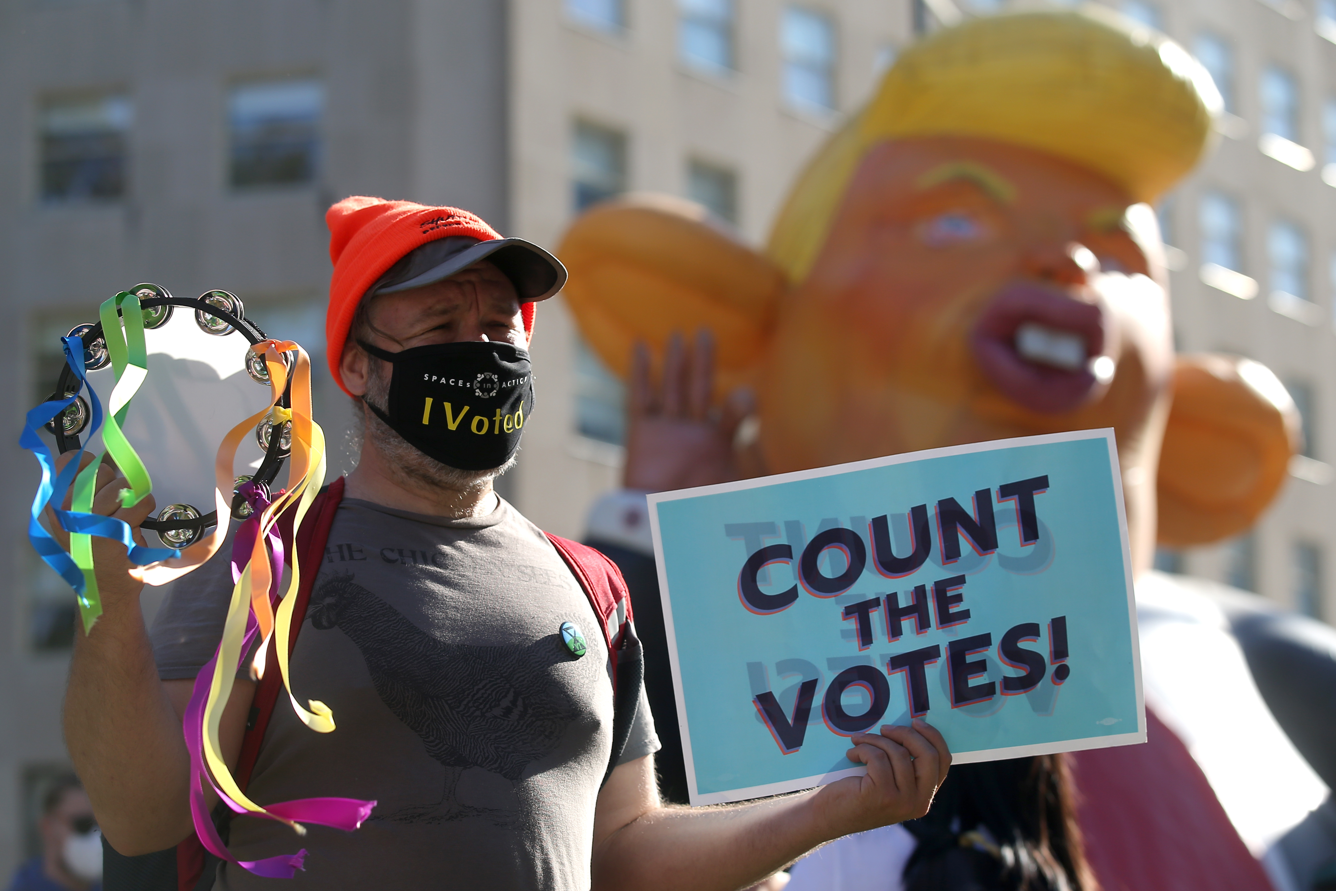 A man in a face mask rallies for a fair vote count in the presidential election in McPherson Square. 