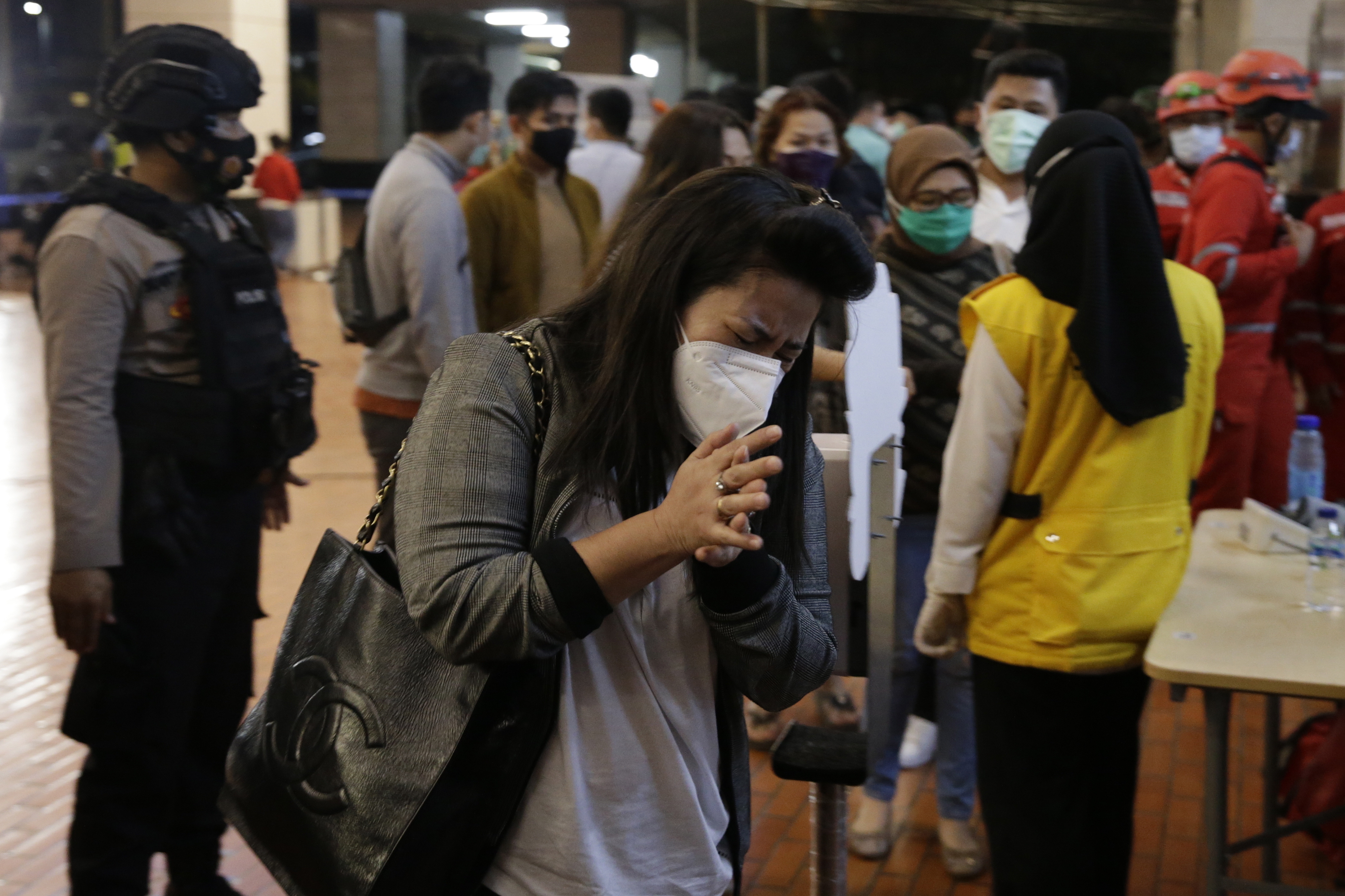 Relatives of passengers arrive at a crisis centre at Soekarno-Hatta International Airport in Tangerang 