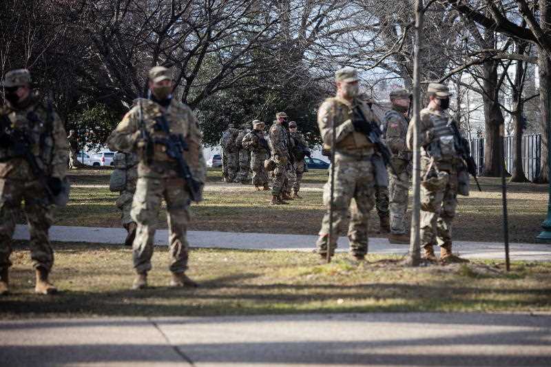 Members of the National Guard keep an eye on the security perimeter around the Capitol building. 