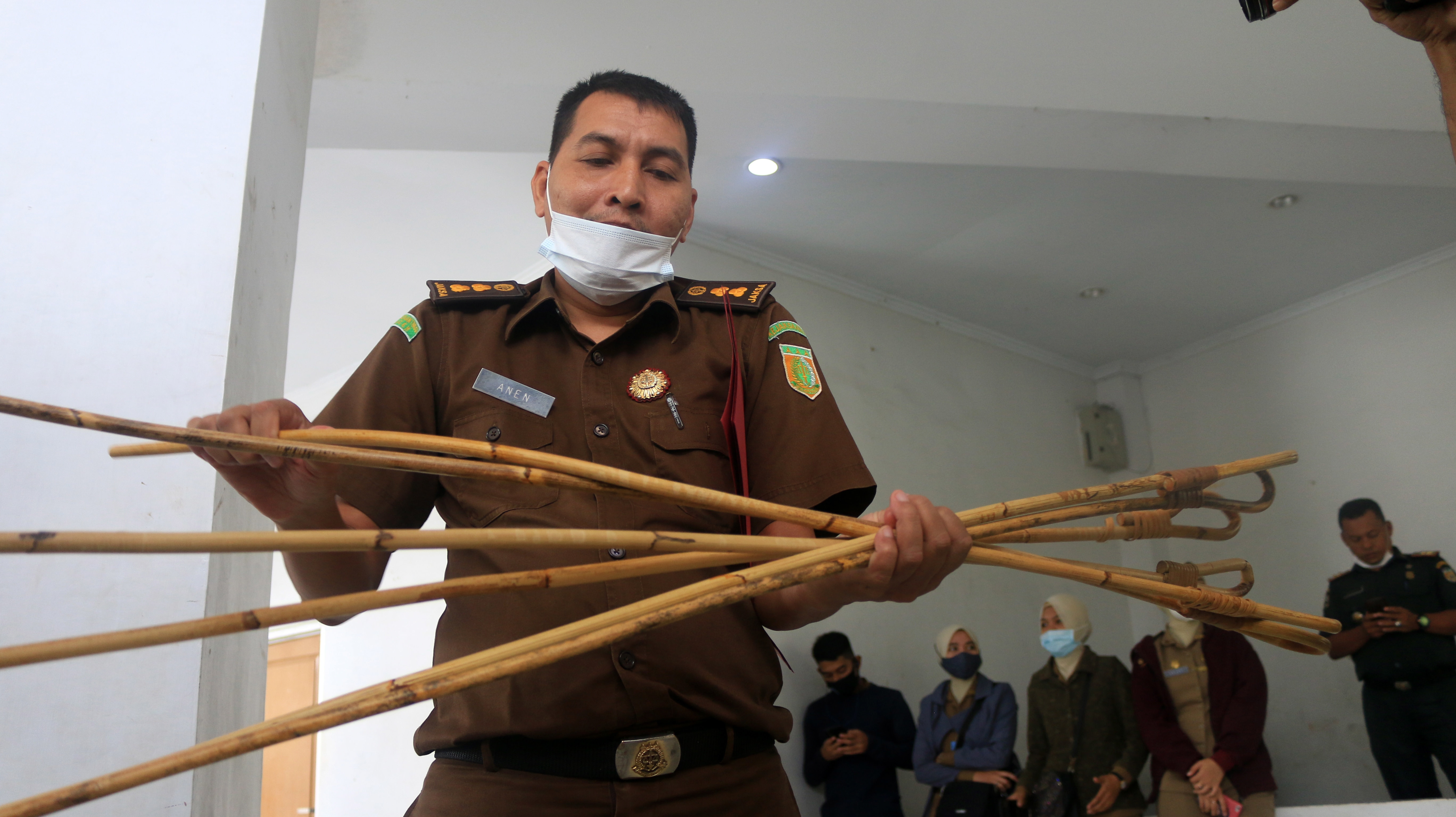 An Aceh prosecutor displays the rattan rods uses to punish sharia violators, in Banda Aceh, Aceh, Indonesia, on 28 January.