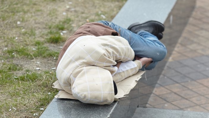 homeless man sleeping on the street