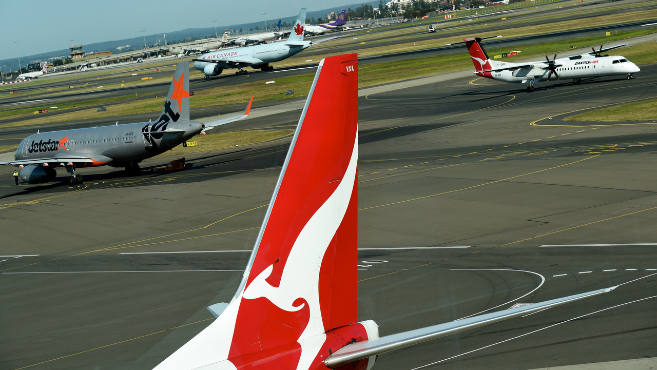 Qantas, Jetstar and an Air Canada plane on the runways at the domestic terminal in Sydney.