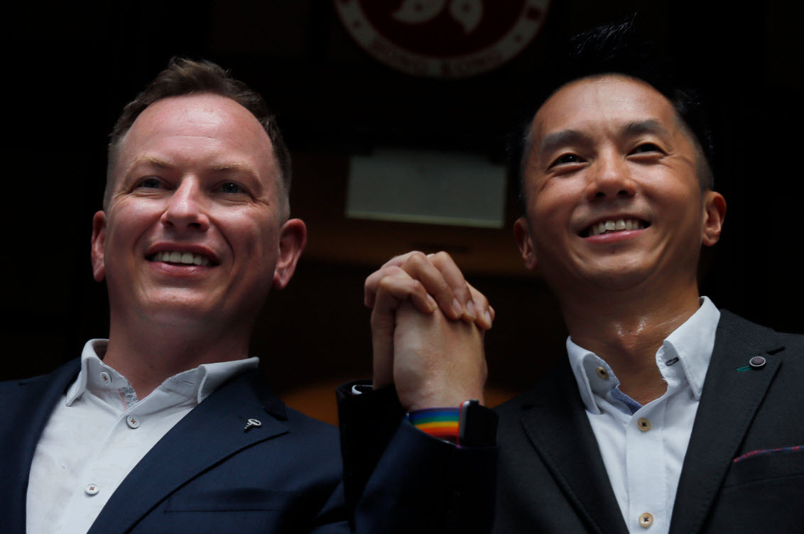 Angus Leung Chun-kwong, a senior immigration officer, right, and Scott Adams, a same-sex couple who married in New Zealand (AAP)