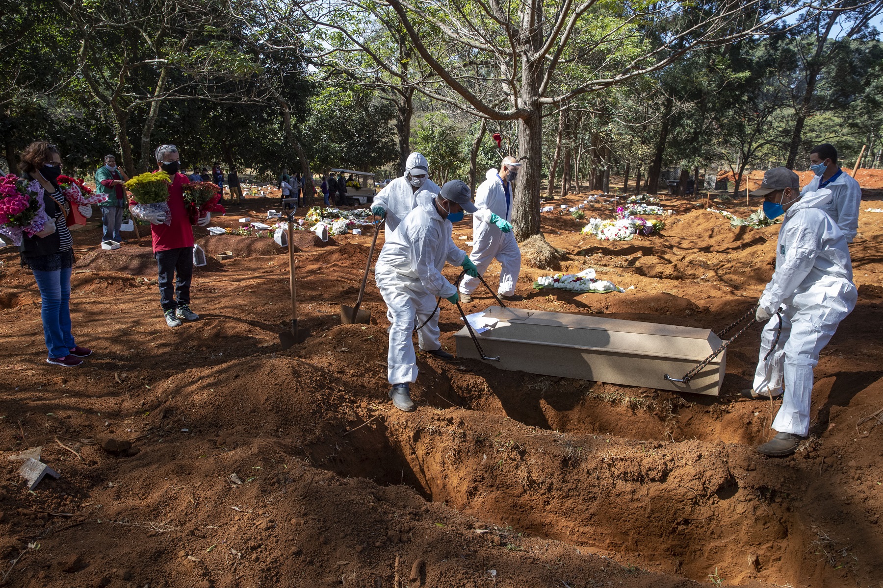 Cemetery workers in protective clothing bury the bodies of COVID-19 victims at the Vila Formosa cemetery in Sao Paulo, Brazil.