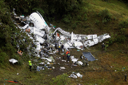 In this Nov. 29, 2016 file photo, rescue workers recover a body from the wreckage site of the LaMia chartered airplane crash