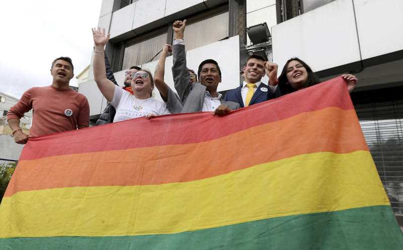 People celebrate outside the court in Quito, Ecuador, after judges ruled in favour of gay marriage.