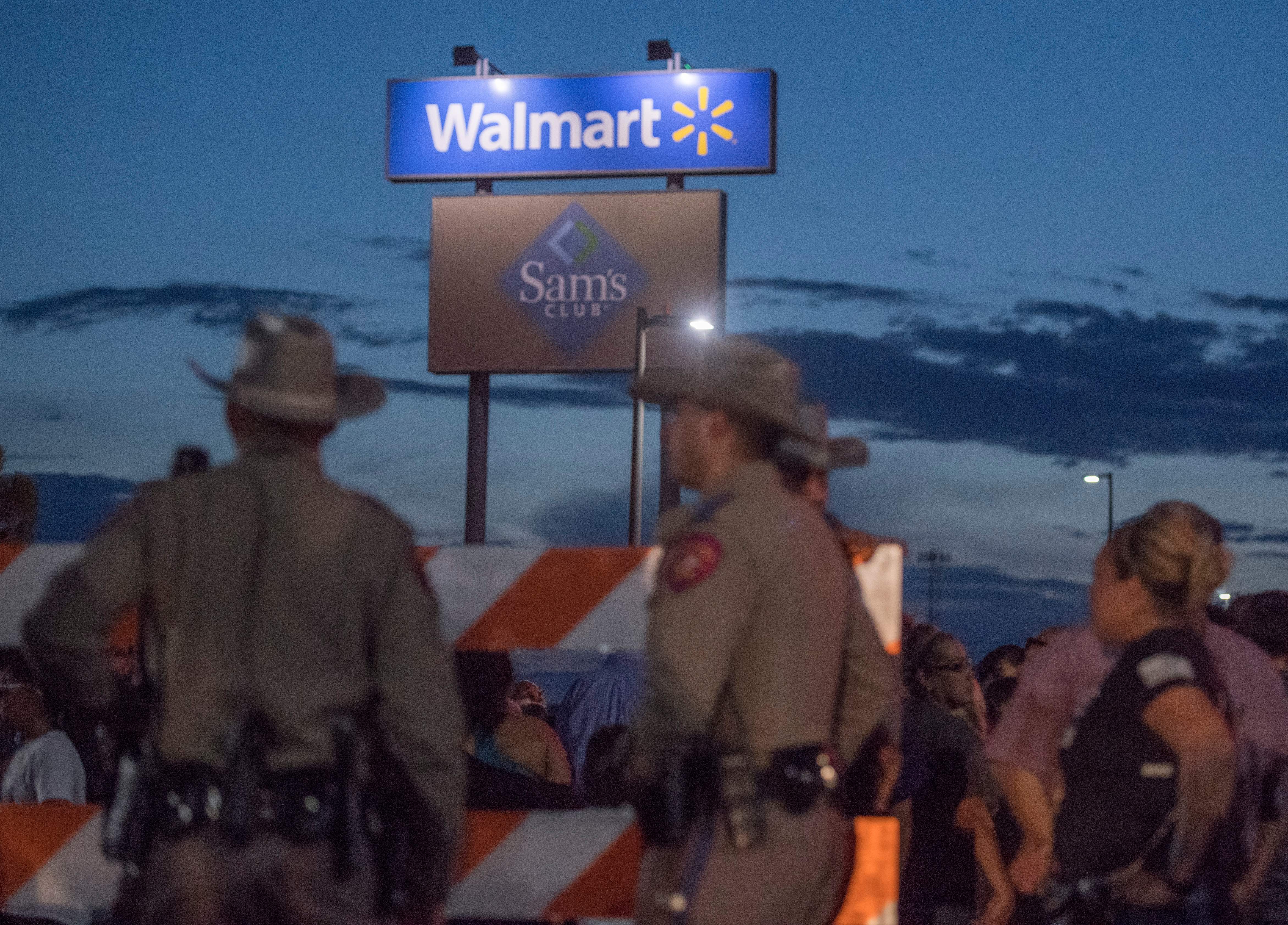 Texas State Troopers keep watch at the makeshift memorial for victims of the shooting that left a total of 22 people dead at the Cielo Vista Mall WalMart.
