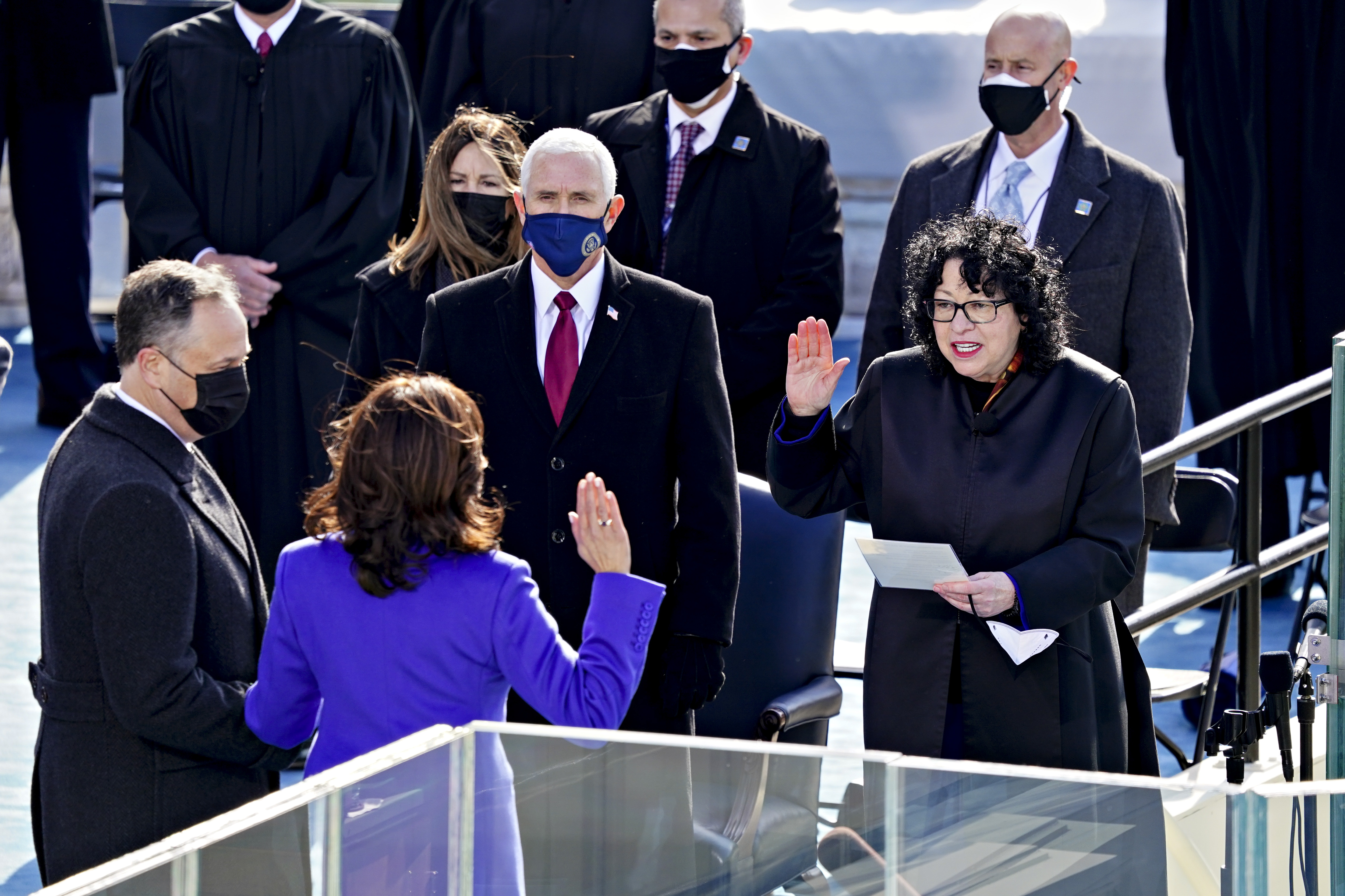 Outgoing vice-president Mike Pence watches on as his successor Kamala Harris is sworn into office. 