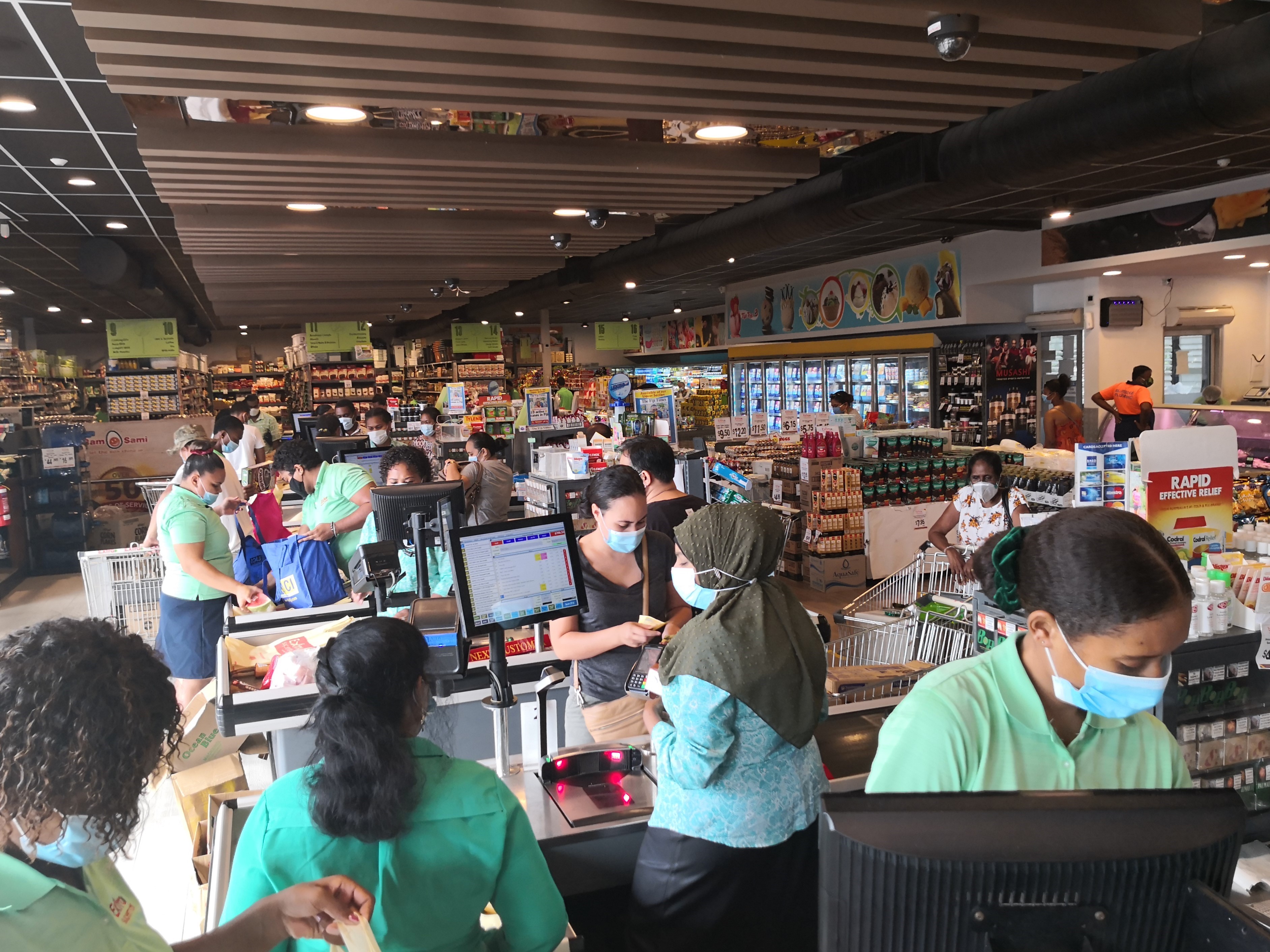 People wearing face masks are seen at a supermarket amid the COVID-19 pandemic in Suva, Fiji, 23 April, 2021.