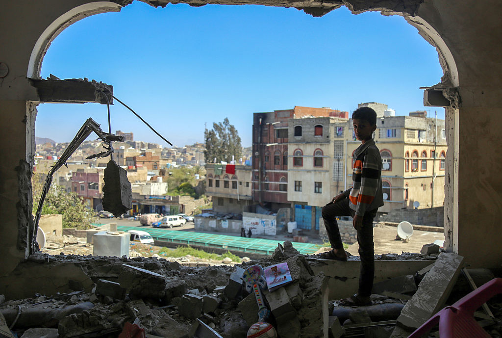 A Yemeni boy among the damage in the country's southern city of Taez following a mortar shell attack in February 2016.