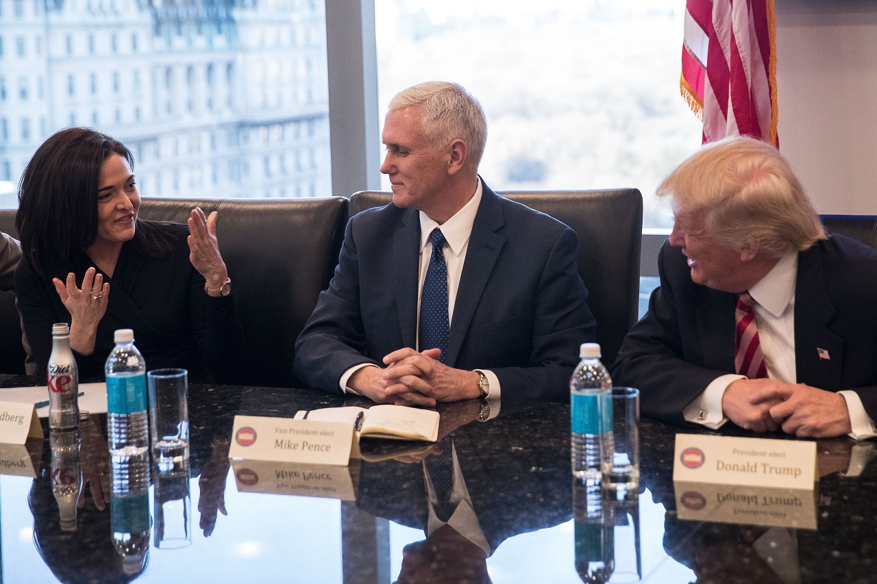 Sheryl Sandberg, COO of Facebook, speaks with  Vice President Mike Pence and President Donald Trump during a meeting of technology executives.