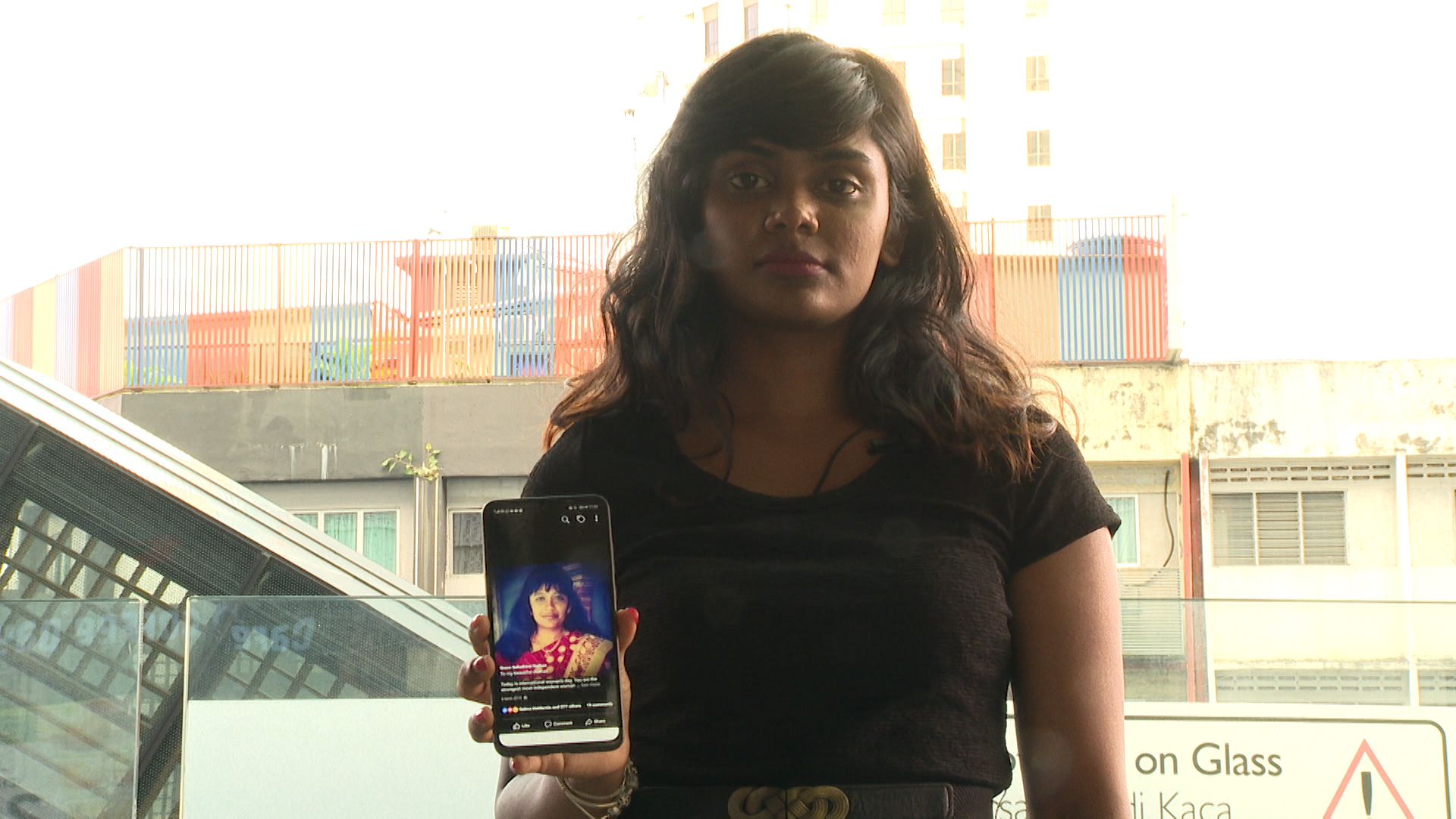 Grace Subathirai Nathan holds up a picture of her mother.