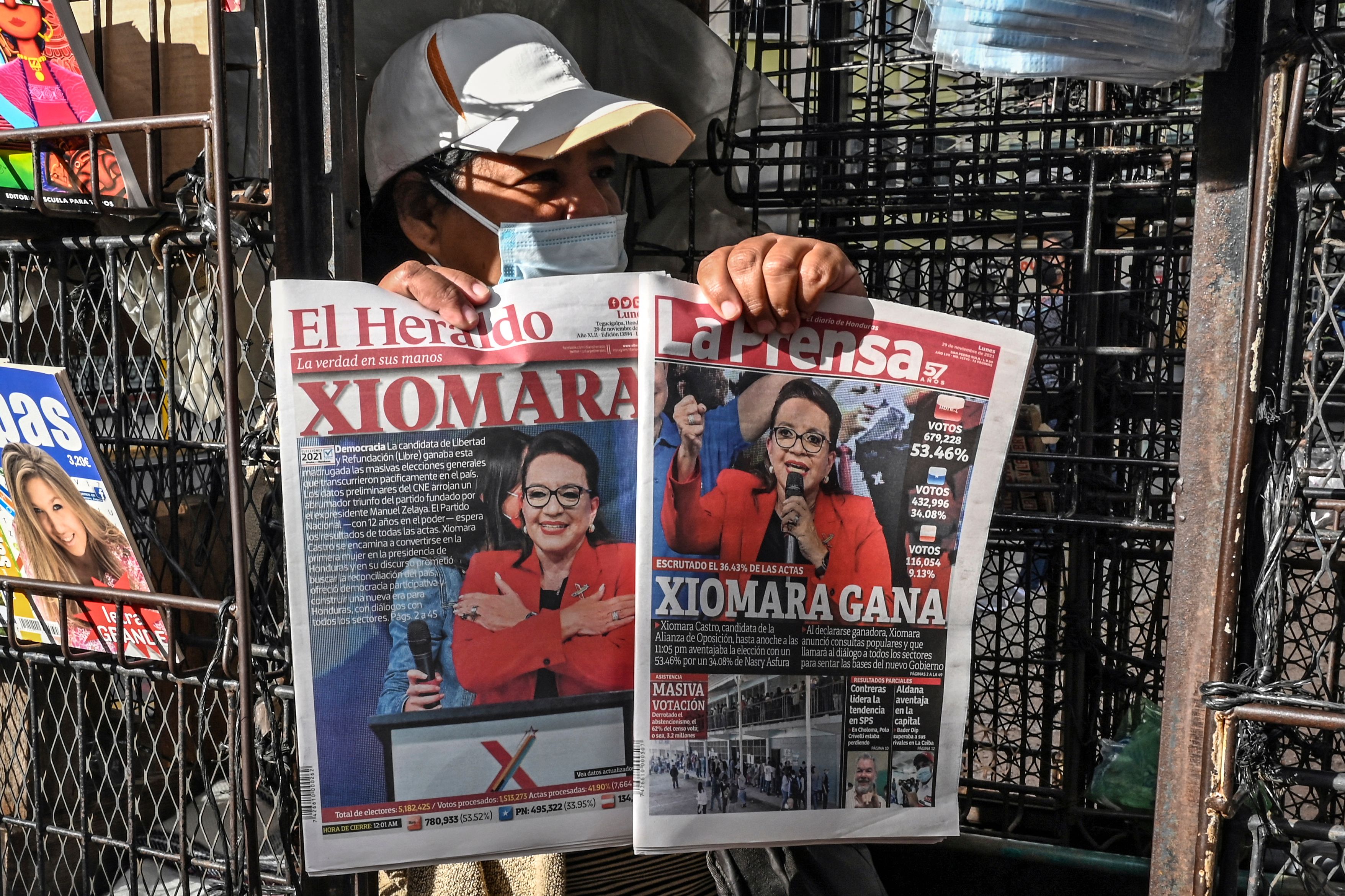 A vendor shows the covers of newspapers depicting left-wing opposition candidate Xiomara Castro, in Tegucigalpa on November 29, 2021.