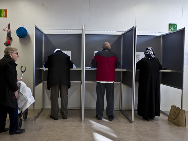 People fill out ballots prior to casting their votes