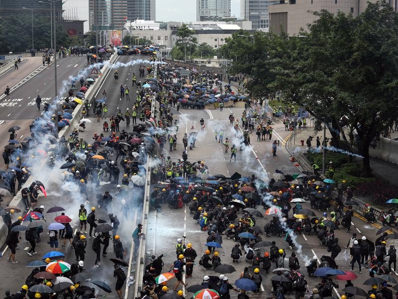 Hong Kong police fire tear gas at protesters.