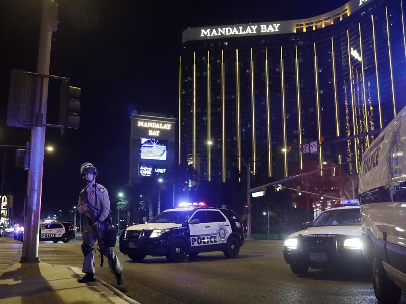 Police officers stand on the Las Vegas Strip following the shooting.