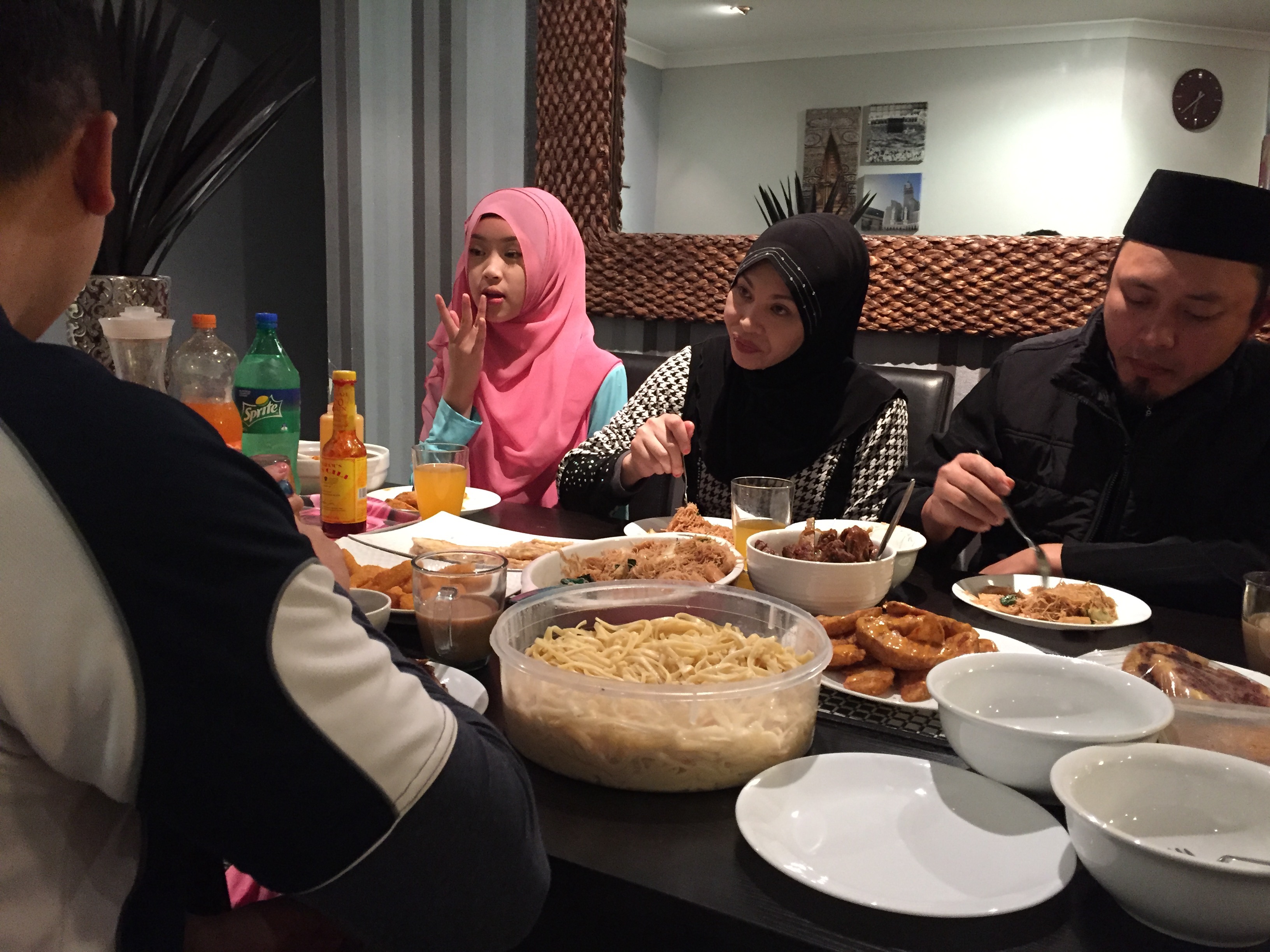 Siti Aeson, her husband Hadimansah Hadirin and one of their daughters Hafizah Hadimansah break fast with the Iftar dinner