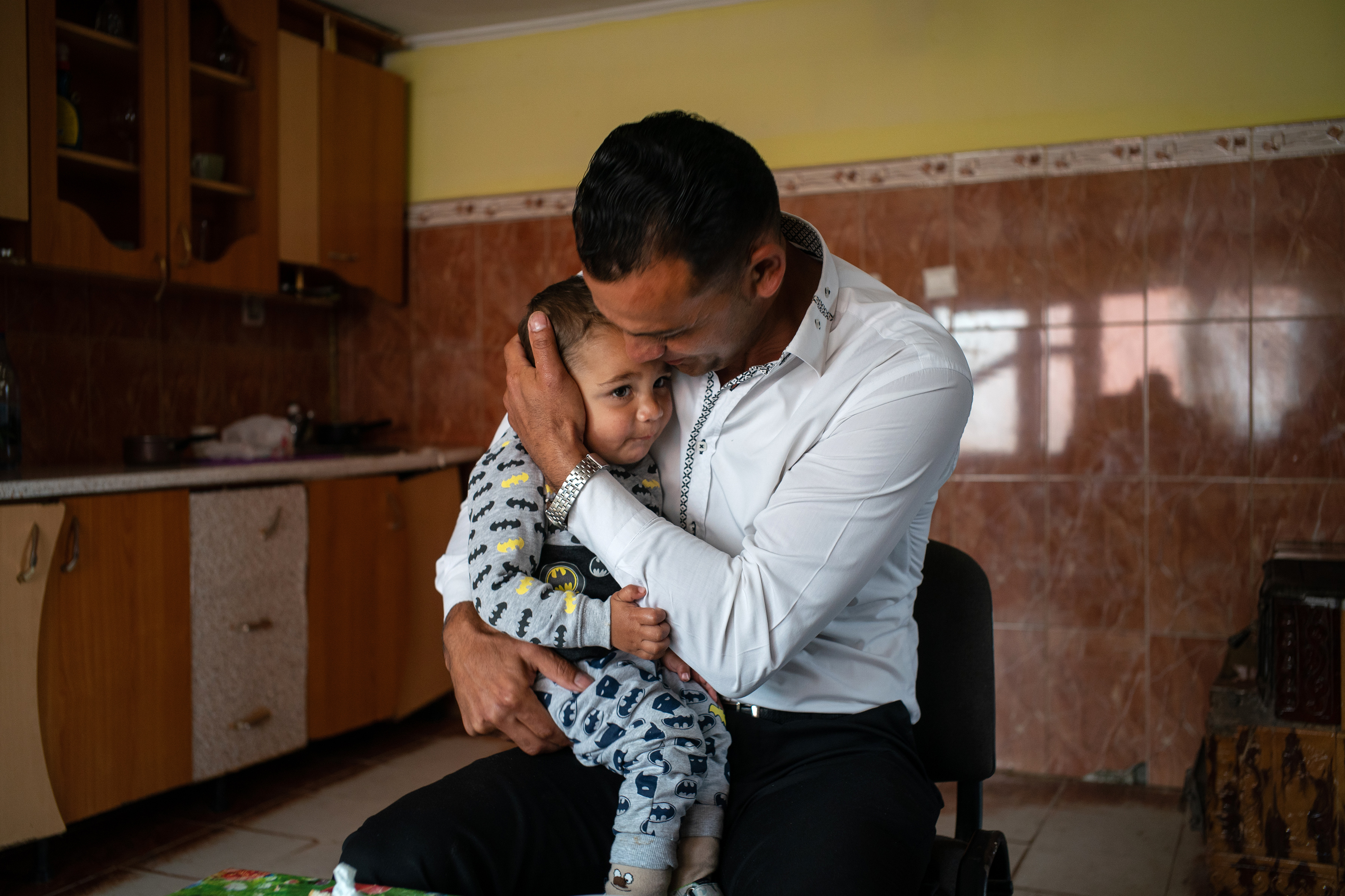 Vasile Mutu with his youngest child, Constantin, 1, in Olteni, Romania.