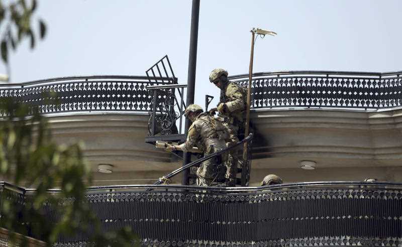 Special forces prepare their weapons on top of a building during a clash between insurgents and security forces, in Kabul.