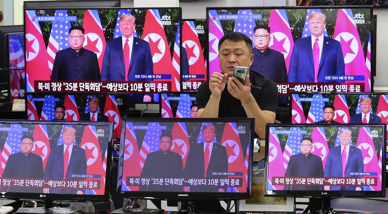 TV screens show the US President Donald Trump's, right, meeting with North Korean leader Kim Jong-un.