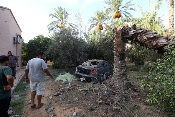 Libyans gather at the site of where a mortar shell landed in the capital Tripoli.