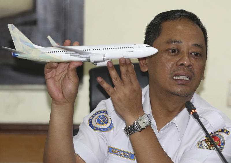 Indonesian National Transportation Safety Committee investigator Nurcahyo Utomo holds a model of a Boeing737 MAX 7 as part of the Lion Air investigation. 