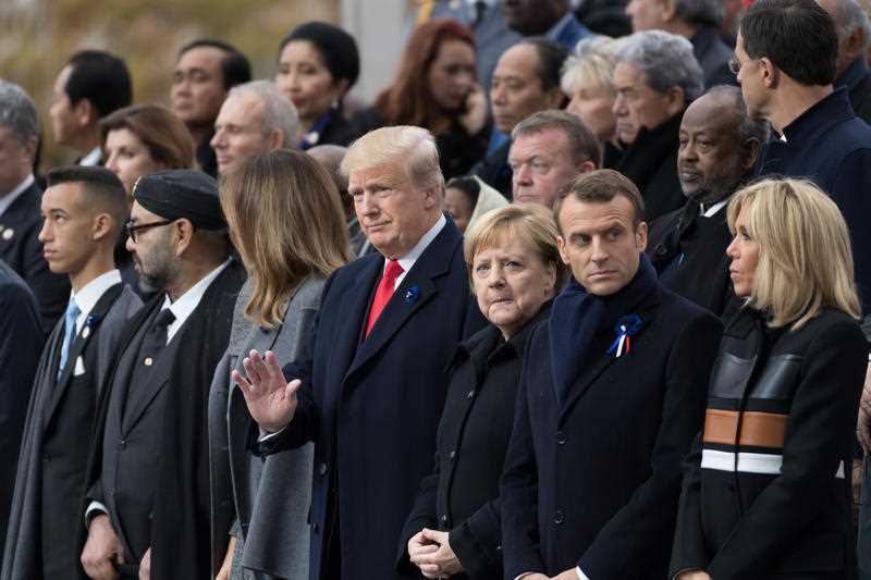 US President Donald Trump waves to the crowd, next to German Chancellor Angela Merkel, French President Emmanuel Macron and Brigitte Macron.